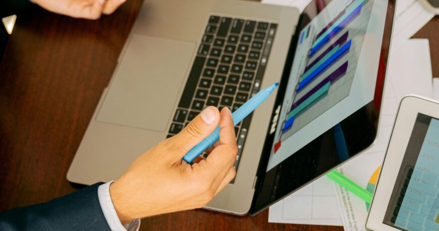 Free A Person in Black Suit Holding a Pen Stock Photo